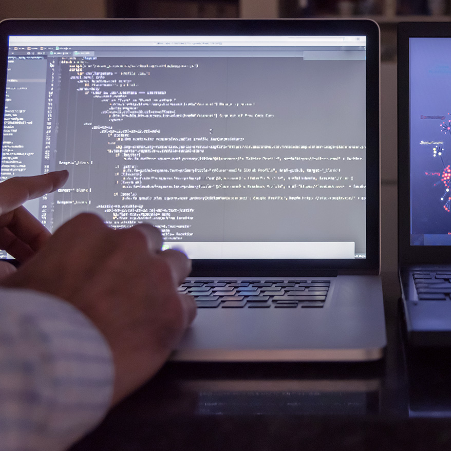 employee typing on laptop